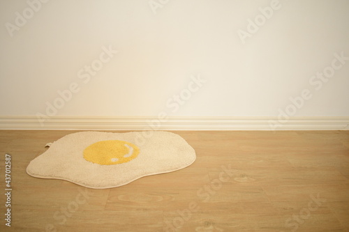 white fried egg floor mat on muji minimal style room white and warm mood background