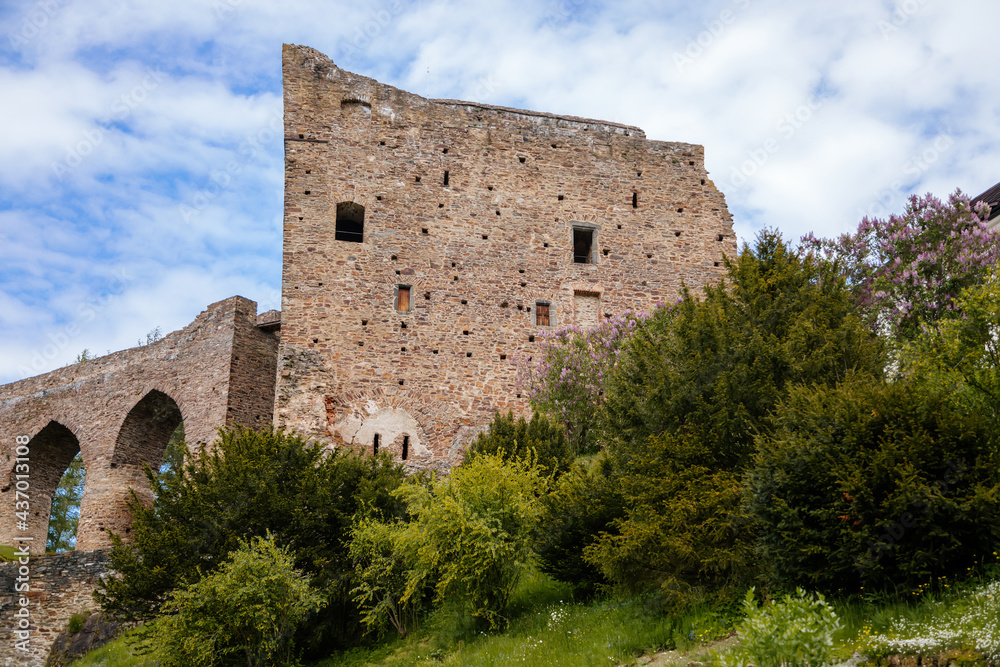 Gothic medieval castle Velhartice in sunny day, tower and stone arch bridge, fortress masonry wall, old stronghold, Velhartice, National Park Sumava, South Bohemia, Czech Republic