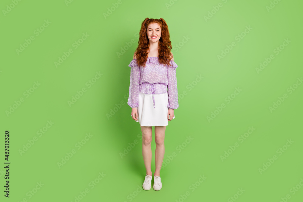 Full body photo of cute ginger hairstyle young lady stand wear blouse skirt isolated on green color background Full body photo of cute ginger hairstyle young lady stand wear blouse skirt isolated on green color background