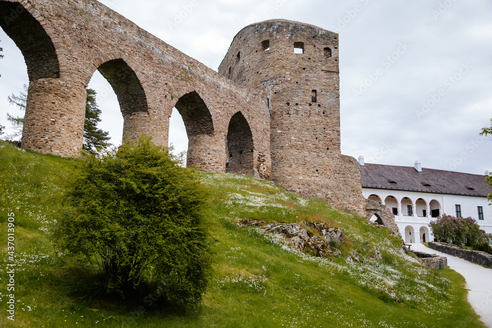Gothic medieval castle Velhartice in sunny day, tower and stone arch bridge, fortress masonry wall, old stronghold, Velhartice, National Park Sumava, South Bohemia, Czech Republic