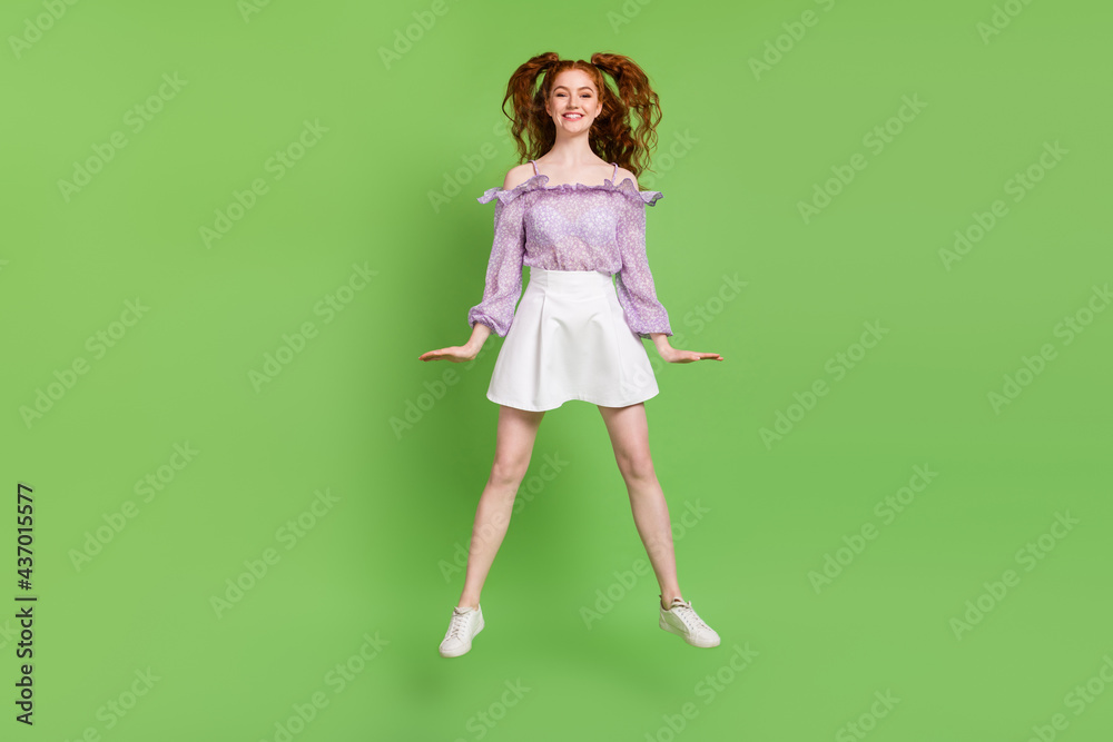 Full length photo of funky orange hairstyle millennial lady jump wear blouse spectacles skirt isolated on green color background