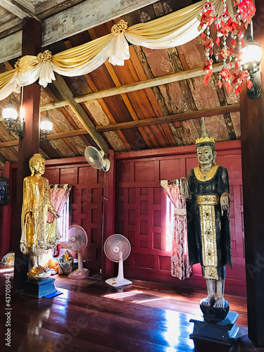 Trat, Thailand - December 20, 2020:  Buddha image in the wooden prayer hall of Buppharam temple (Wat Buppharam or Wat Plai Khlong) in Trat, Thailand. photo