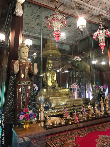 Trat, Thailand - December 20, 2020:  Wooden Buddha image in the wooden prayer hall of Buppharam temple (Wat Buppharam or Wat Plai Khlong) in Trat, Thailand. photo