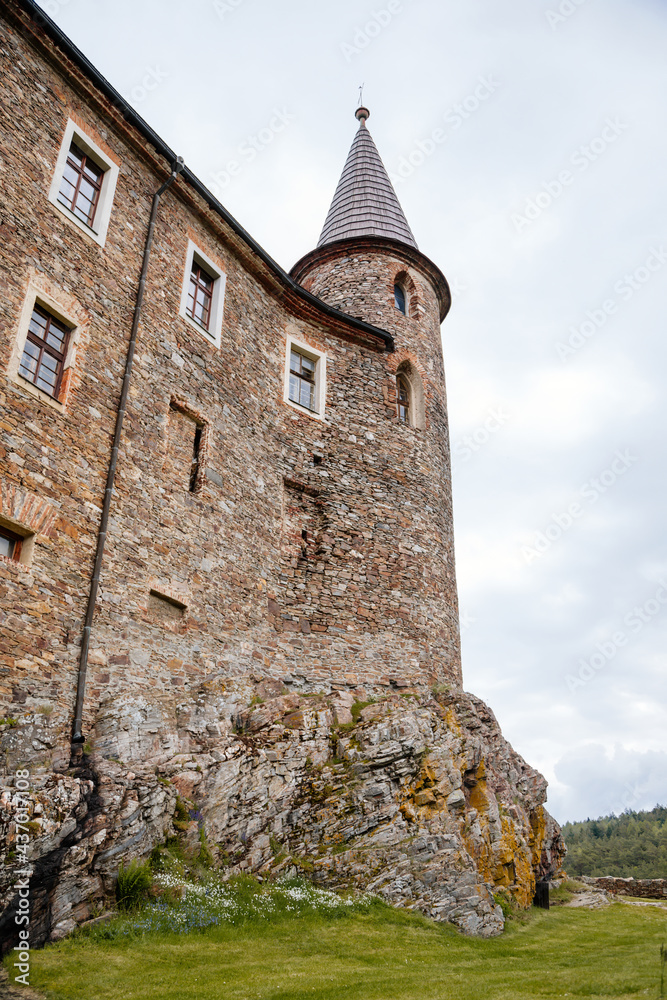 Gothic medieval castle Velhartice in sunny day, tower at the hill near forest, fortress masonry wall, old stronghold, Velhartice, National Park Sumava, South Bohemia, Czech Republic