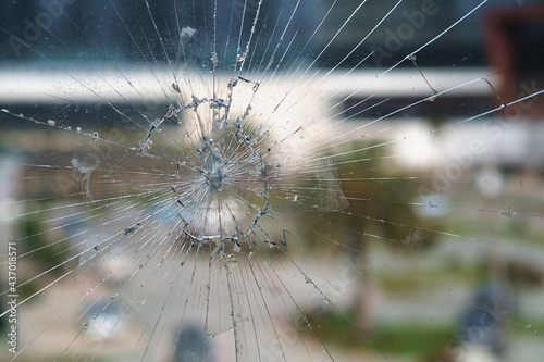 Broken glass, glass cracked from an accident, blurred background