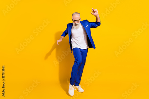 Full size photo of funny grey beard old man dance wear spectacles blue jacket isolated on yellow background