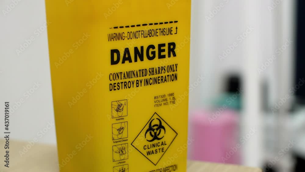 Real yellow tank with warning labels. Waste caused by technology are ...