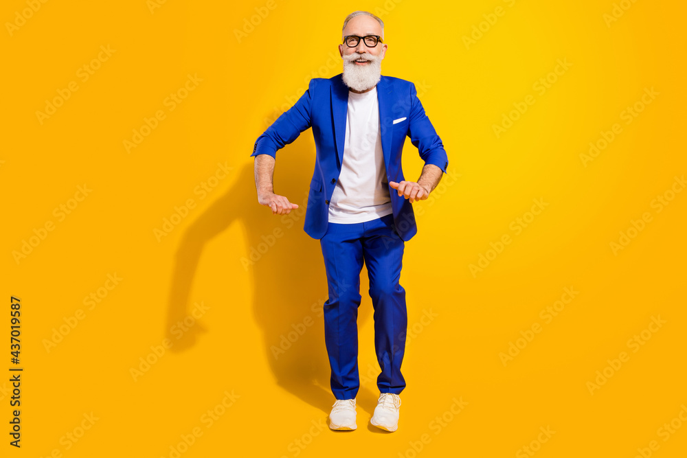Full length photo of funky funny happy old man dance good mood smile wear shoes isolated on yellow color background