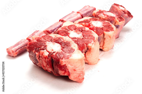Tableau sur toile Raw uncooked beef oxtail cut into portions on white isolated background