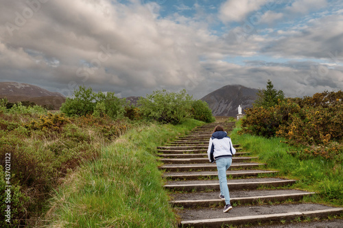 Photography Teenager girl walking on a stair way to Croagh Patrick, county Mayo, Ireland