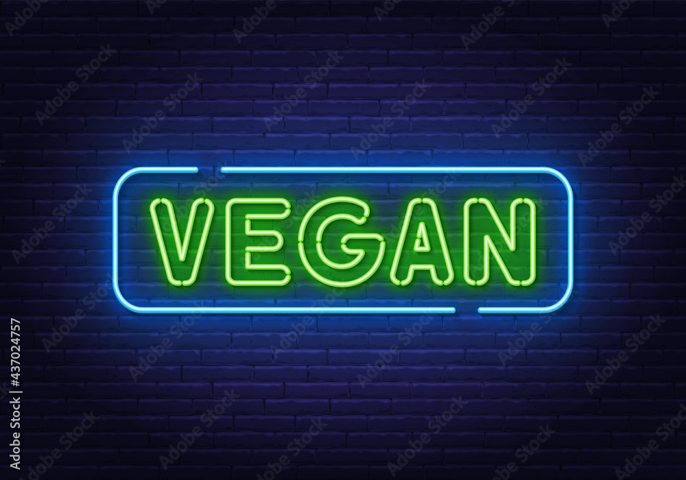 Vegan neon sign on brick wall background.