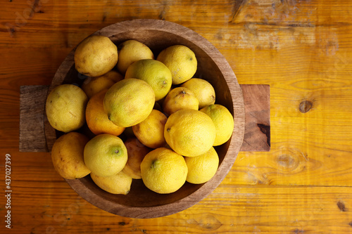 Image of group of fresh lemons over old vintage wooden table