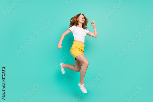 Full length body size photo schoolgirl jumping up running for sale isolated vibrant teal color background