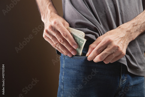 a man puts money in his pocket