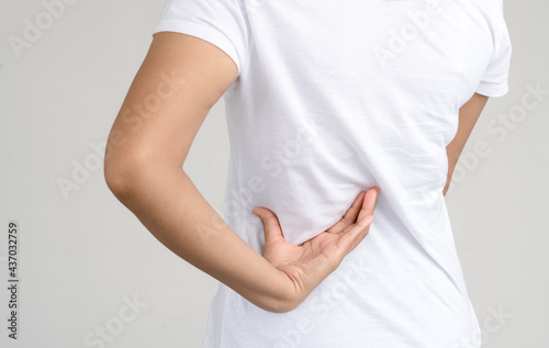 Wallpaper Mural young woman holding his back in pain, isolated on white background,healthy concept Torontodigital.ca