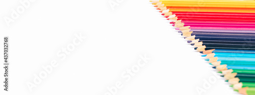 banner, multicolored pencils in a row by color temperature on a white background isolate