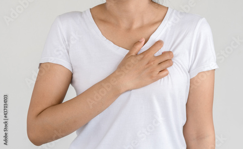 Young female suffering from severe chest pain. Warning signs of unstable angina or myocardial infarction disease. Health care and cardiological concept.