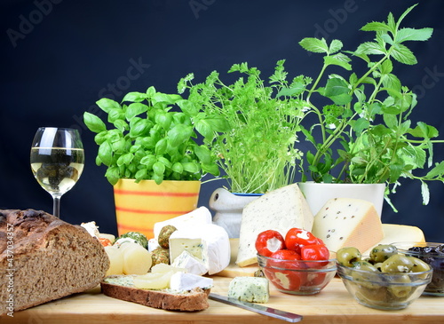 cheeseboard with camenbert, blue cheese, cheese with herbs and pepper and more