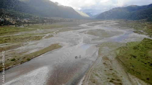 People crossing  the mountain river in Dhorpatan Nepal, aerial video photo