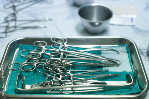 sterile surgical instruments are on a table during an operation. Medical instruments in a steel tray. 