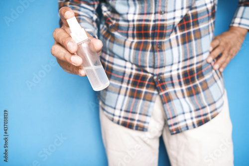 close up of young man hand using hand sanitizer spray.