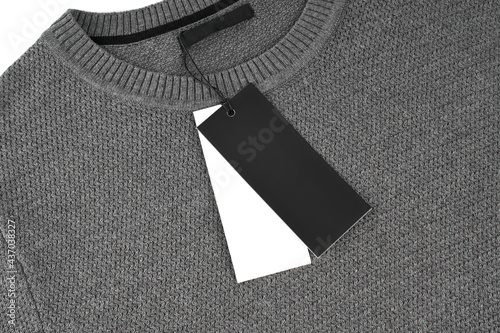 Men's winter sweater. Gray jumper on a white background. Cotton fabric texture. Gray cotton sweatshirt. 