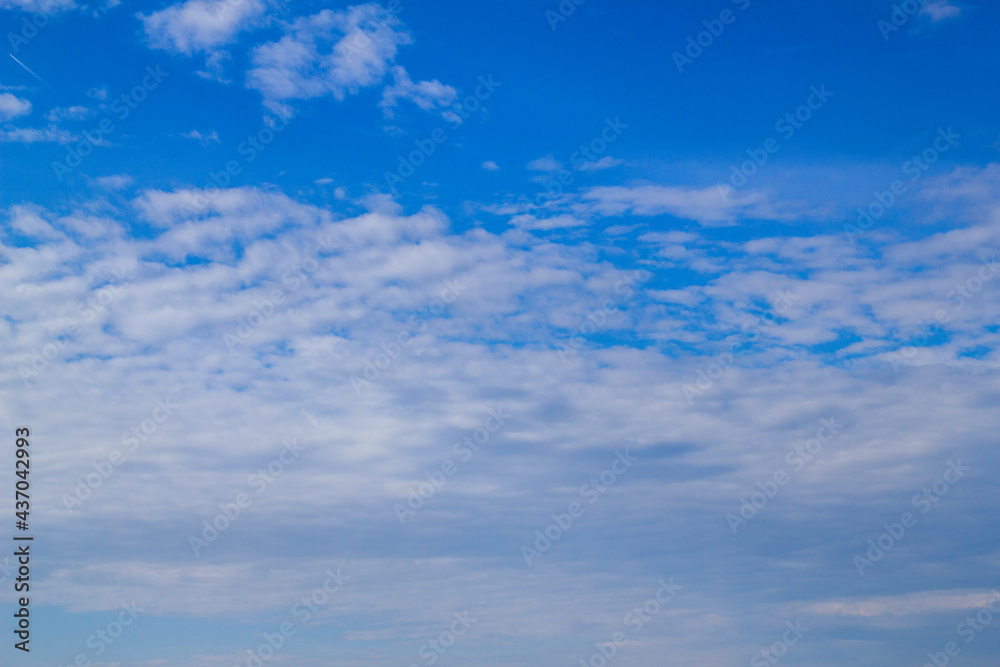 White fluffy clouds on blue sky on a bright sunny summer day