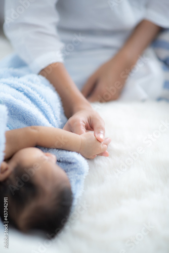 Parent hands holding newbor...