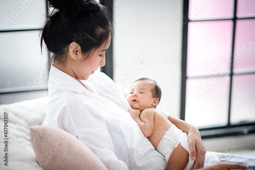 mother holding a newborn in...