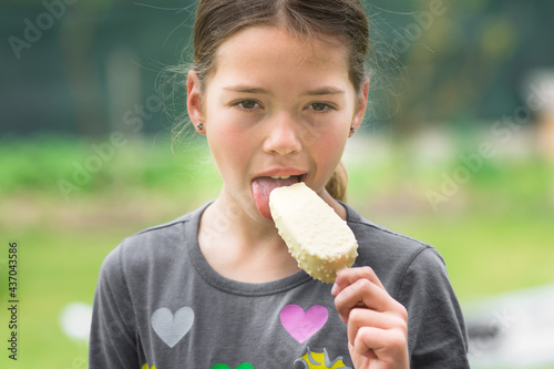 Young girl eating ice cream. Holiday and summer concept. photo