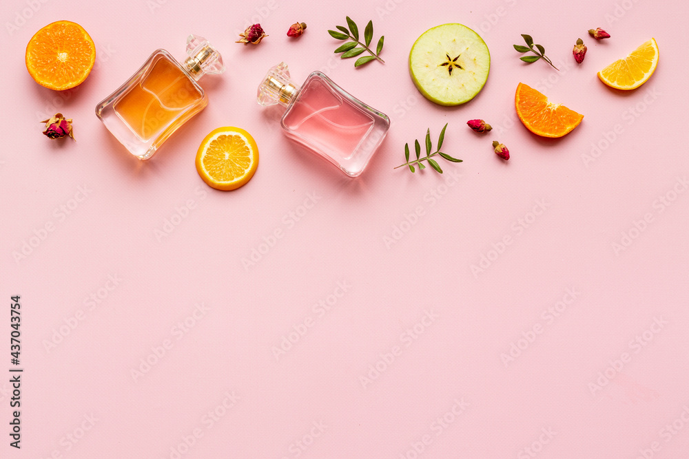 Perfume bottles with flowers leaves and fruits. Overhead view Perfume bottles with flowers leaves and fruits. Overhead view