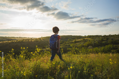 boy with a backpack on a hike