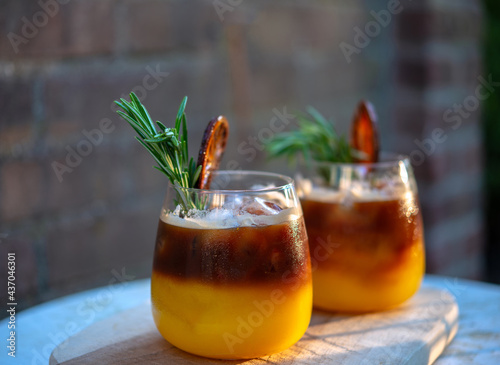 Colorful cocktail Drinks for relaxing afternoon at home. Black Coffee Rum mixed with sweet orange juice on Iced. Creative Iced Coffee with alcohol and orange Juice. Drink after work at home.