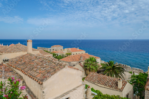 Panoramic View of Traditional House Rooftops in Medieval Castle Town of Monemvasia. Deep Blue Sea and Sky in the Horizon.  Monemvasia Island, Greece © Nikolaos