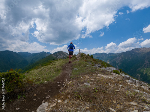 Runner on mountain ridge trail