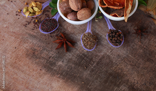 Fototapeta Naklejka Na Ścianę i Meble -  spice background, top view.rotation all indian spices on wooden table,Indian cuisine,Cumin, black pepper, cloves, cardamom, fennel, bay leaf,background rotating,