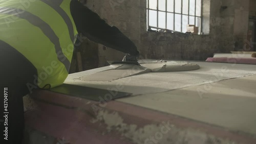 Construction worker plastering surface, Mansfield, Nottinghamshire, UK photo