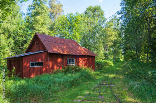 Old red shed at a light railway in the forest