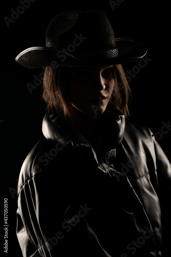 silhouette of a young woman with a cowboy hat