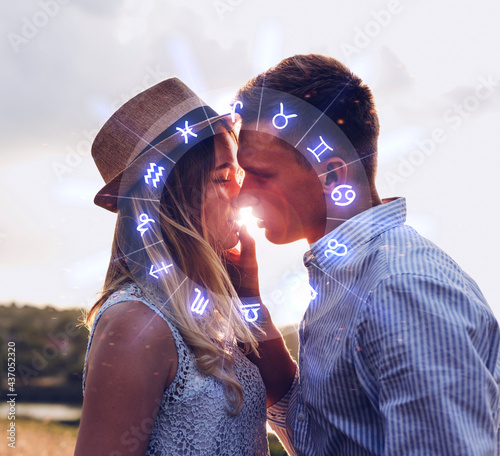 Concept of love compatibility between zodiac signs. Horoscope astrology zodiac.  Couple kissing at sunset. 