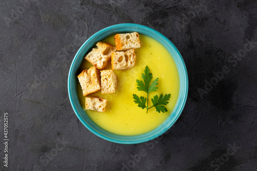 Bowl with onion soup and croutons on the table.