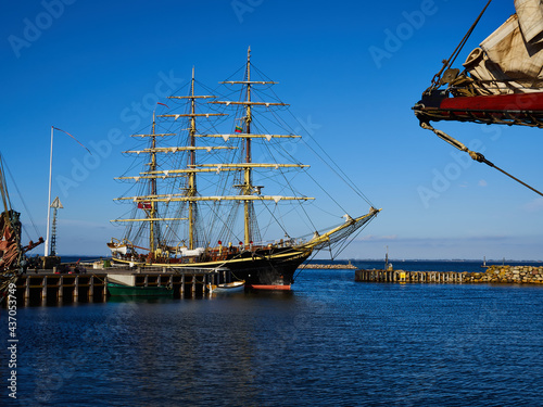 Classicaltall sailing ship enters a port