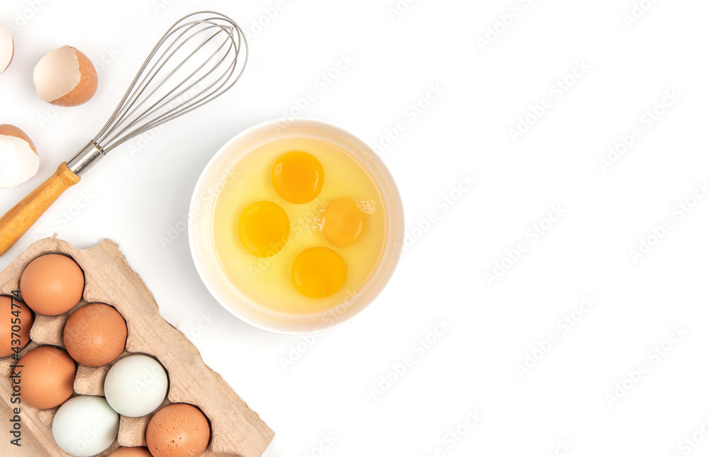 Top view carton box eggs, egg yolk, whisk, Eggshell on a white background. Top view carton box eggs, egg yolk, whisk, Eggshell on a white background.