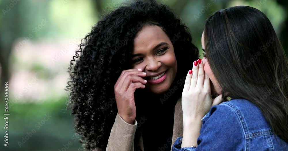 Two girls telling gossip secret. Woman real life laugh reaction Two girls telling gossip secret. Woman real life laugh reaction