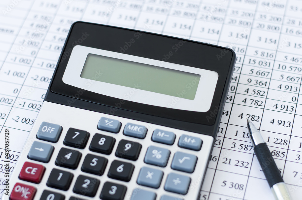 a calculator on the background of financial statements, business concept a calculator on the background of financial statements, business concept