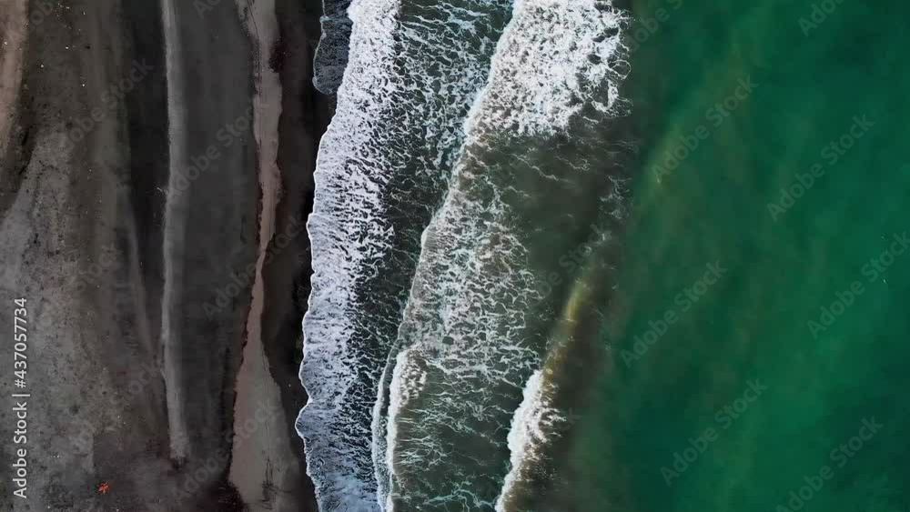 Green blue waves crashing into black sand beach, Philippines Green blue waves crashing into black sand beach, Philippines