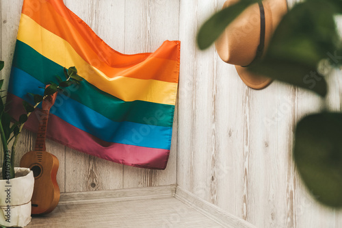 Home balcony interior in hippie style with LGBTQ flag on background and hat. Home office. Stay home