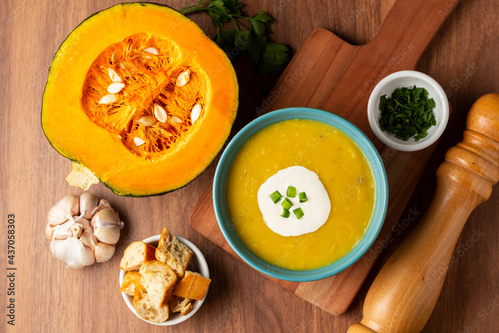 Bowl with pumpkin soup on the table.