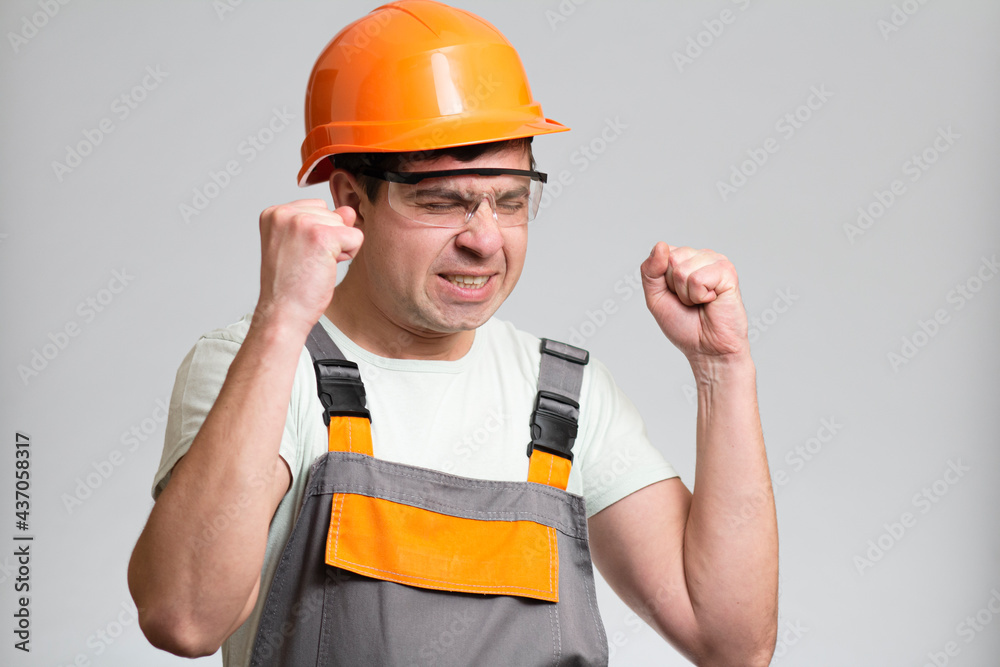 funny young disgruntled foreman in hysterics on gray isolated background, comic emotions on his face funny young disgruntled foreman in hysterics on gray isolated background, comic emotions on his face