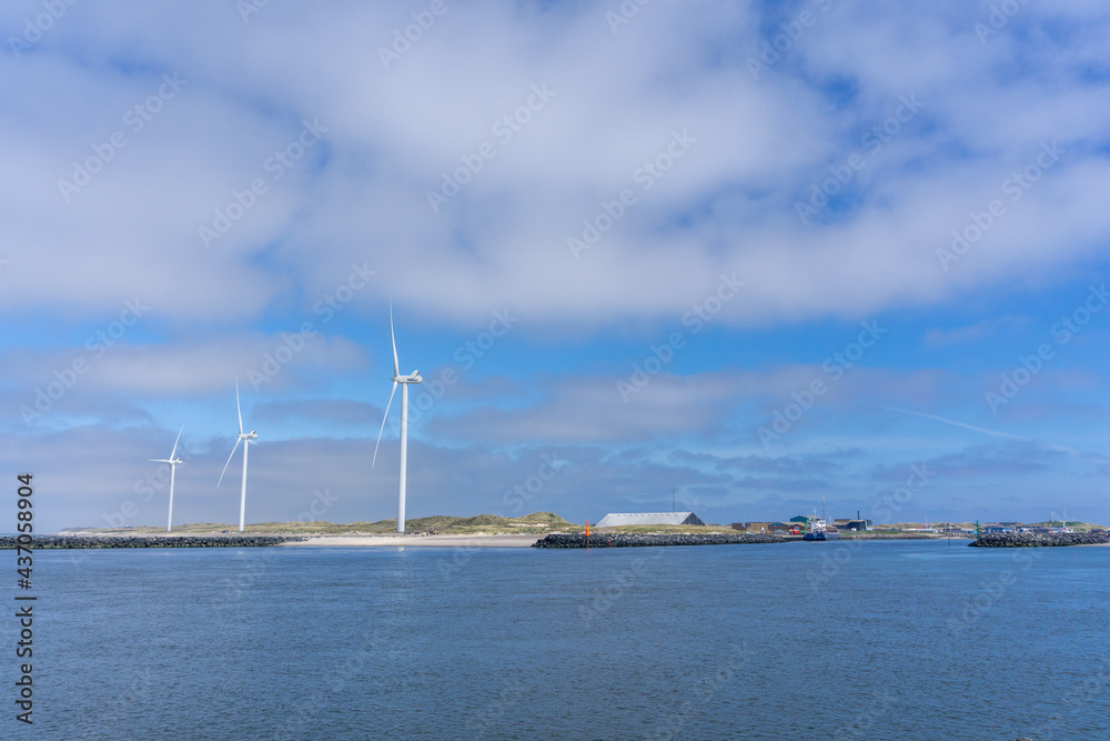 wind turbines on the coast of western Denmark under a blue sky wind turbines on the coast of western Denmark under a blue sky